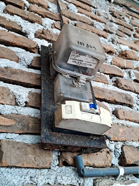 An electric meter is a device that measures the amount of electricity consumed by a household or business. Electric meters are usually mounted on the outside of a building