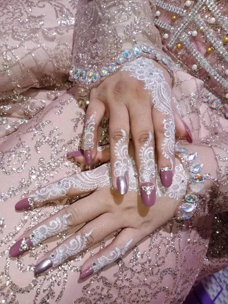 beautiful woman hands with a white manicure