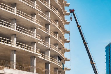 Building construction site with working crane. Industry of housing new buildings. Industrial concept