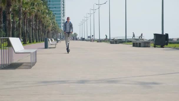 Young Man Riding Electric Scooter Eco Friendly Transport Promenade City — Stock Video