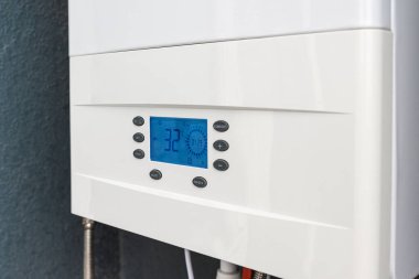 Close up of smart control panel of gas boiler for winter home heating and hot water. Modern house device.