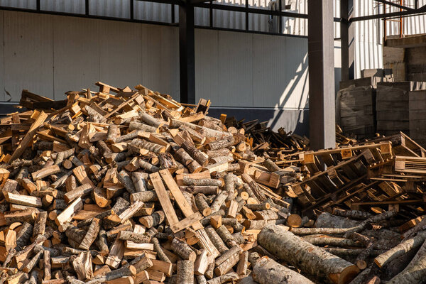 Stacking Firewood. Pile of firewood loggs. Preparation for winter heating season. Firewood background.