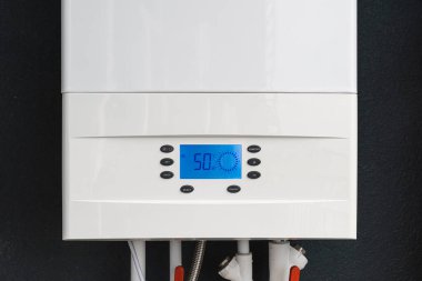 Close up of smart control panel of gas boiler for winter home heating and hot water. Modern house device.