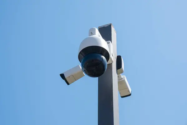 CCTV camera monitoring system with panoramic view outdoor against blue sky. Safety system. Technology concept.