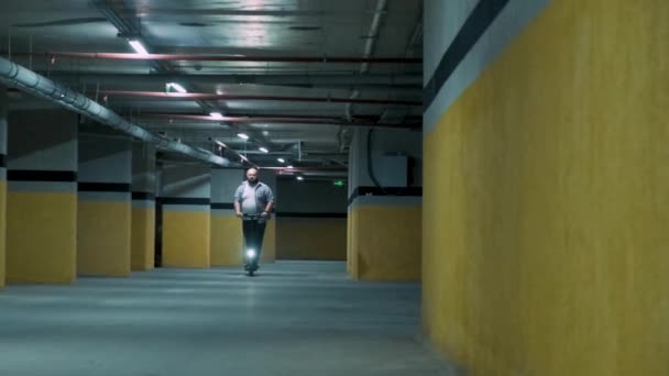 Übergewichtiger Mann Fährt Scooter Tiefgarage Männliche Ersetzen Ein Auto Auf — Stockvideo