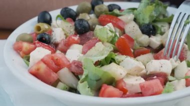 Sebzeli Yunan salatası, peynirli peynir ve çatallı zeytin yemek. Akdeniz diyet yemekleri. Kapat..