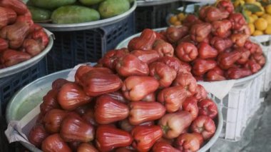 Vibrant display of fresh tropical fruits for sale at traditional food market in Phu Quoc, Vietnam. Rose apples, mangoes and loquats displayed at Vietnamese street market. Agriculture, farming and