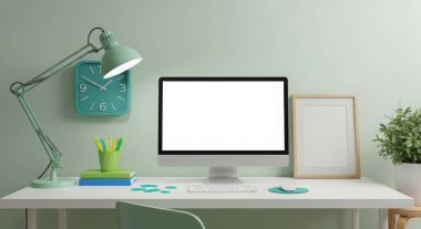 Modern workspace setup featuring a computer with a blank screen, lamp, clock, picture frame and plant on a white desk against a light green wall. Mockup scene.