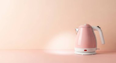 A pink electric kettle isolated on a pink background with copy space. Perfect for showcasing kitchen appliances, tea, coffee, and hot beverage concepts. Studio shot.