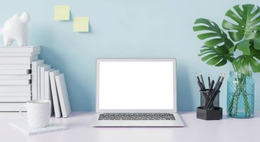A laptop with a blank screen on a desk with books, a plant, and a coffee mug in an office. Perfect for adding your own text or images. Great for business.