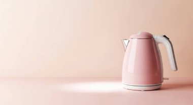 A pink electric kettle for boiling water in the kitchen. Perfect for making tea or coffee. Modern and stylish design. Isolated on a white background in studio.