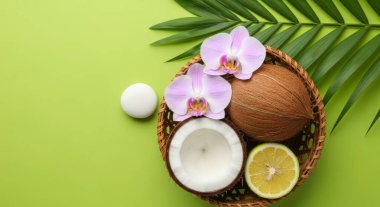 Hindistancevizleri, orkide çiçekleri ve yeşil zemine karşı bir palmiye yaprağından oluşan canlı bir kompozisyon. Yaz temaları, sağlık ve doğal güzellik için mükemmel..