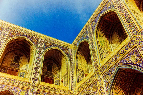 Old Asian medieval architecture with yellow arches landscape and blue sky copy space in Samarkand Uzbekistan