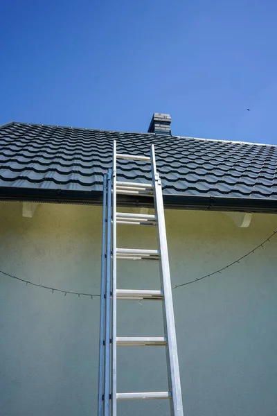 stock image Ladder on the roof. Ladder leading to the roof. House cleaning.