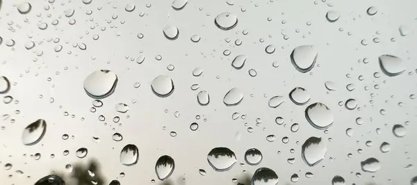 Rain drops on the window. Raining. Close up of the rain drops.