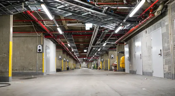 Geceleri ışıklar açıkken büyük bir depo. Forkliftleri olan büyük bir mağaza..