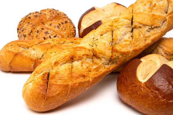 Bakery product assortment Fresh crispy French bread baguette with garlic butter and herbs, kaiser roll bun with linseeds and sesame seeds, traditional German laugenbrot, Bavarian homemade pretzel rolls lye bread isolated on a white background.