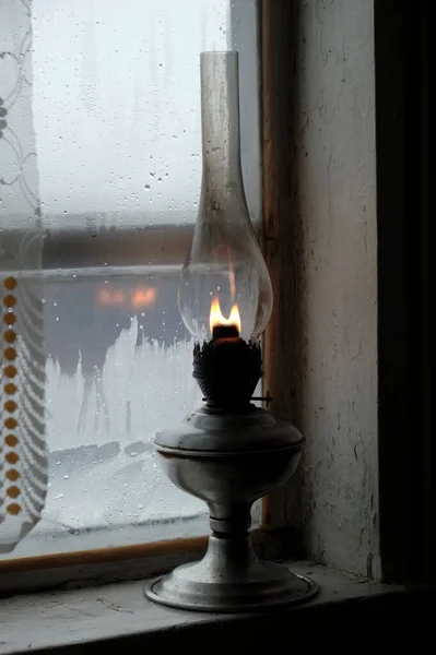 old gas lamp on a window sill, lantern, close-up