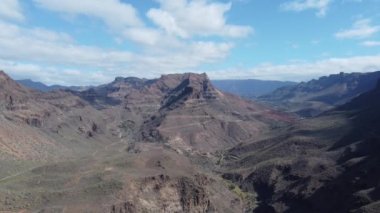 Stunning drone footage captures the majesty of Gran Canarias mountains. Soar above peaks and ridges, witnessing breathtaking views and raw beauty