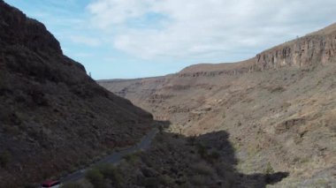 Stunning aerial view of road winding through Gran Canarias mountainous landscapes. Dynamic drone flight over the Canary Islands