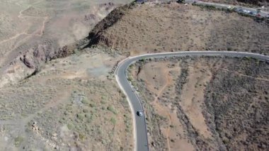 Stunning aerial view of road winding through Gran Canarias mountainous landscapes. Dynamic drone flight over the Canary Islands