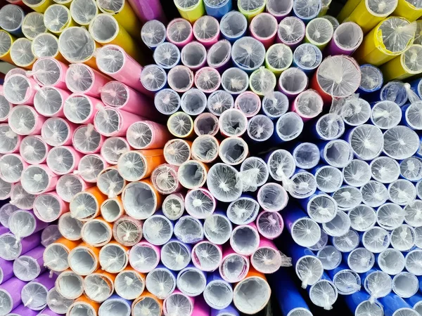 Colorful paper rolled up and wrapped in plastic