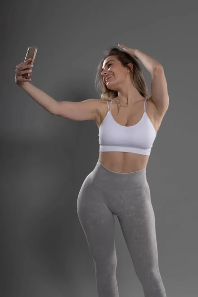 Young Attractive Fitness Girl Posing Taking Selfie Studio Gray Background — Stock Photo, Image