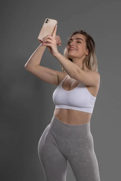 Jovem Atraente Fitness Menina Posando Mostrando Bíceps Tomando Selfie Estúdio — Fotografia de Stock
