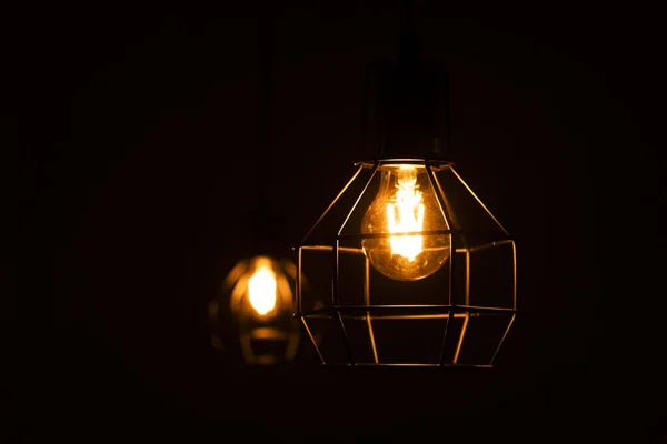 modern loft style ceiling light and decorative edison lamp on dark background