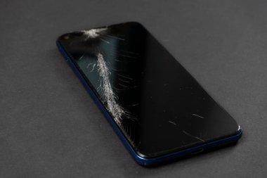 Çatlaklı modern akıllı telefonun kırılmış ekranı.