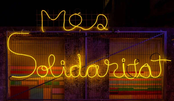Illuminated words made with neon lights and yellow LEDs. Jazz poster aesthetic. Wires and tubes linked to create shapes.