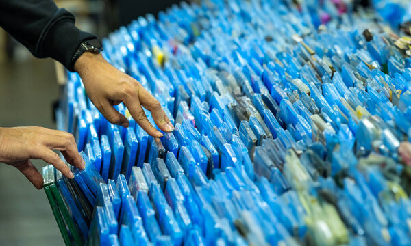 Hands searching and choosing movies and dvds on a shelf in a movie collectors store and selling movie disc merchandising and flea market collectibles