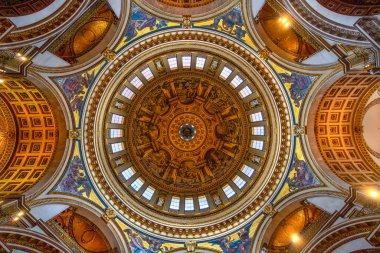 View from below in nadir plane of the interior decorated with mosaics, paintings, sculptures and frescoes of the dome of the ceiling of St Paul's Cathedral in London.