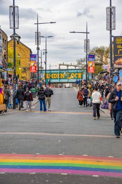 Camden High Street in the Camden Town neighborhood with many people walking looking at the shops and the zebra crossings with the rainbow colors of the lgbtiq+ clipart