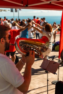 Trumpeter playing a flugelhorn playing Catalan folk music at an  clipart