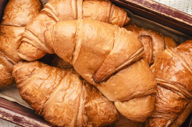 Freshly baked golden brown french croissants. Delicious sweet croissants concept. traditional hommade french pastries for breakfast. Croissant for puff pastry advertising. Croissant for a magazine