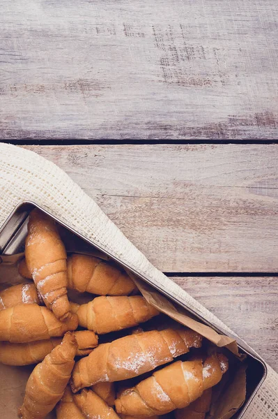 Freshly baked croissants on wooden background Warm Fresh Buttery Croissants and Rolls. homemade baking. Bagels. Cosiness.