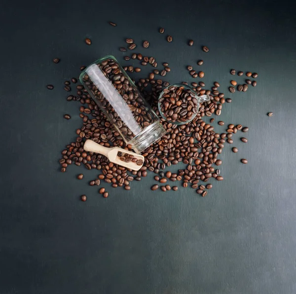 stock image Coffee beans texture or coffee beans background. Brown roasted coffee beans.  Coffee beans can be used as a background. Cezve, cup, jar and scoop with coffee beans.Top view, flat lay