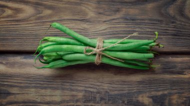 Raw green asparagus beans. Healthy vegetarian food concept background, fresh green food selection for detox diet,  asparagus, tomato, parsley, dill, celery, garlic, pepper, basil ,salad ,top view .
