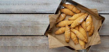Perfect Croissant Breakfast in the morning. Rustic style. Top view. Mockup. Homemade cakes on a wooden background. Fragrant croissants. Baked goods croissant.