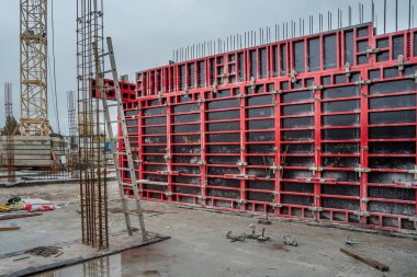 Vertical formwork panels on the construction of a residential buildin clipart