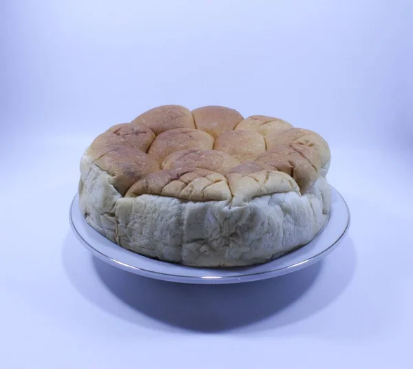 Bread or torn bread or roti sobek (in Indonesia) containing cheese, strawberry jam and chocolate inside. White isolated background.