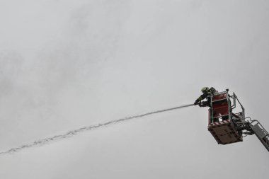 Turkey,Konya;2018 March 01;Firefighter uses cannon to fight fire flame in house. Firefighter safety disaster accident and public service concept
