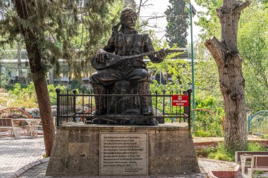 Tarsus, Mersin Türkiye, 19 Nisan 2024: Ünlü halk şairi Karacaoglan 'ın Alayan Şelaleleri bahçesindeki heykeli.