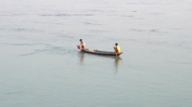 Bir adam sahilde balık tutuyor.