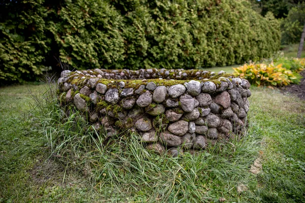 stock image An abandoned masonry well stands in an old garden. High quality photo