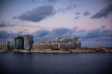 General view of the city under construction through the water barrier. Sea, coastal city. High quality photo