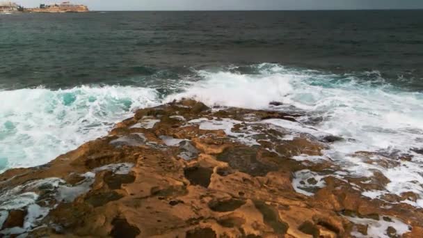 Stone Cliff Washed Blue Waves Ocean Drone Slow Motion Footage — Vídeo de Stock