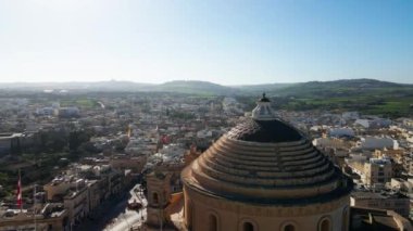 Flight over the high spire of the tower, around the house of the surrounding city. Shooting from a drone. High quality 4k footage