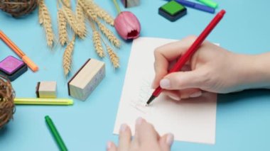 Womens hands sign a holiday card for Easter. Happy easter. High quality 4k footage